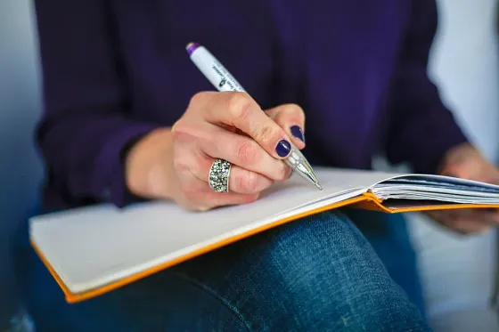 Writing in a notebook — application and enquiry preparation