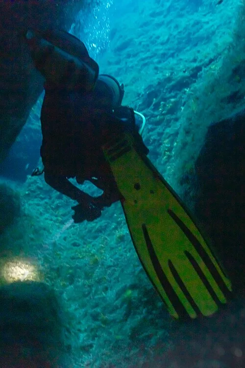 Diver leaving Cathedral Cave, Gozo