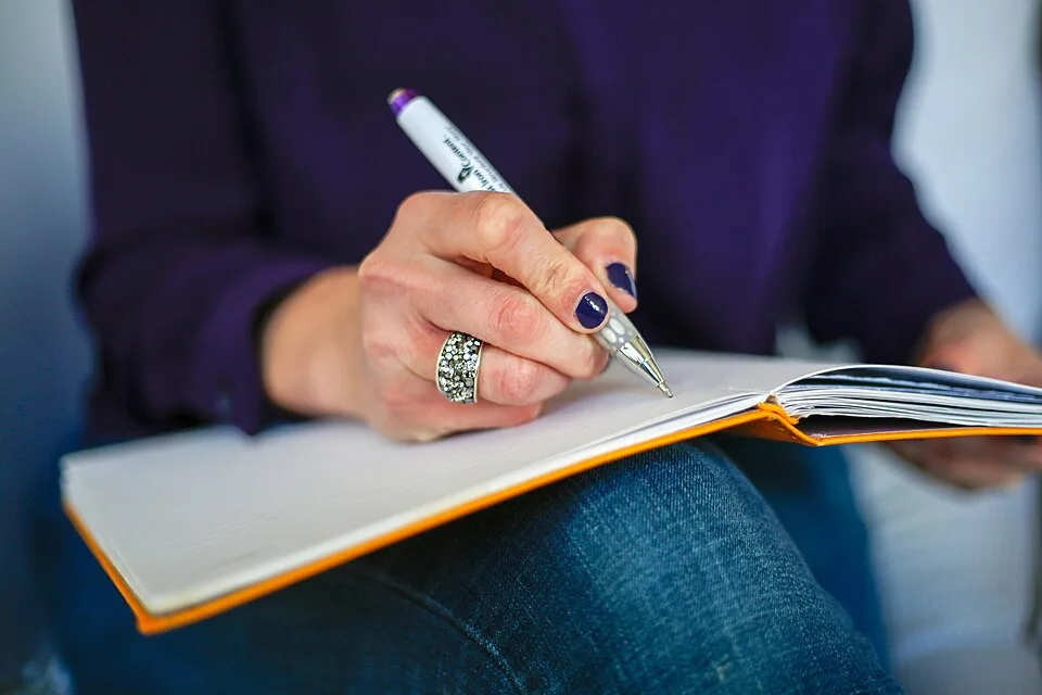 Writing in a notebook — application and enquiry preparation